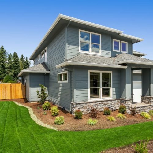 Facade of home with manicured lawn